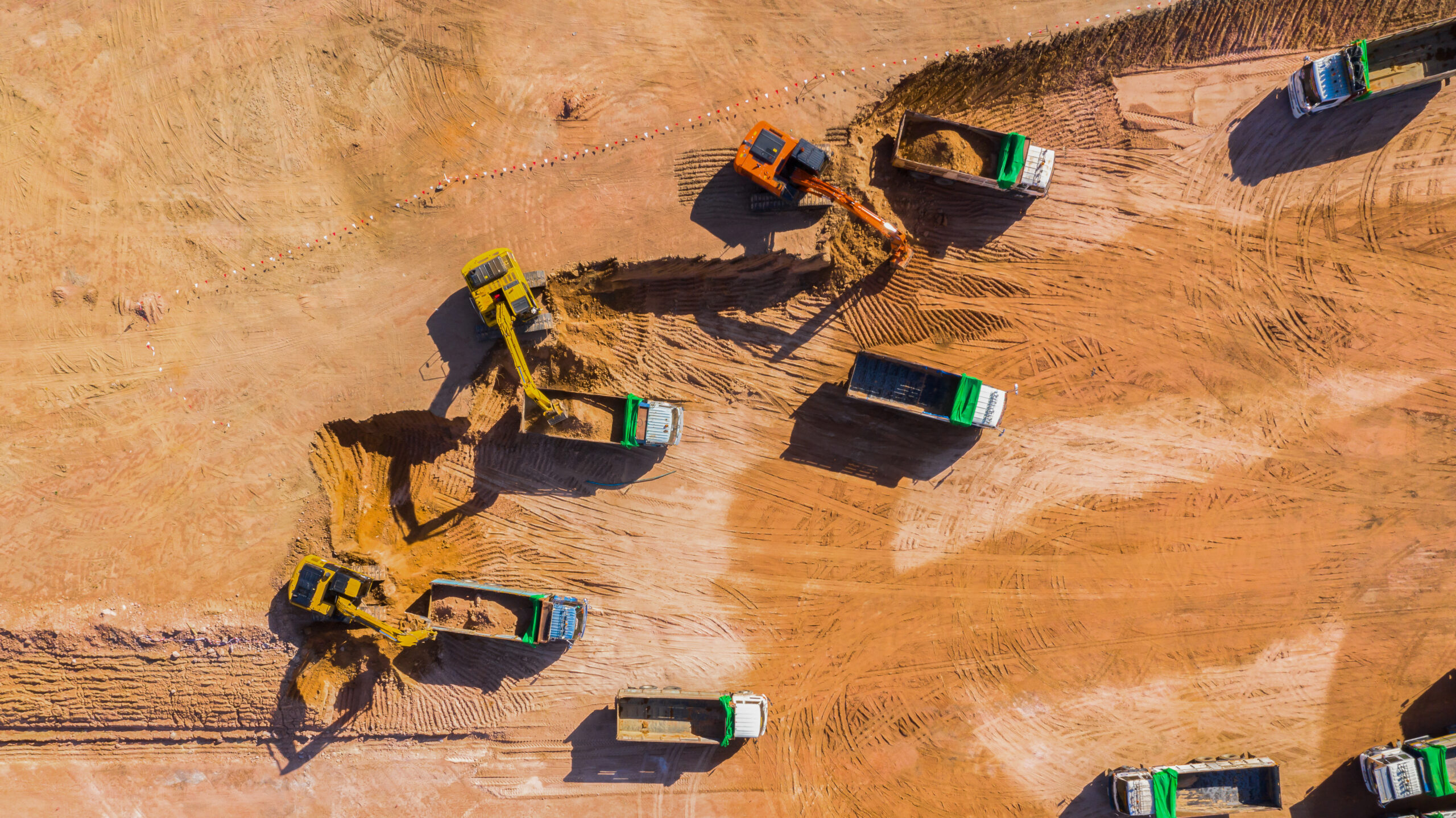 Aerial view road motor grader flatting dirt road surface, Motor